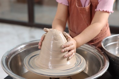 Photo of Hobby and craft. Girl making pottery indoors, closeup