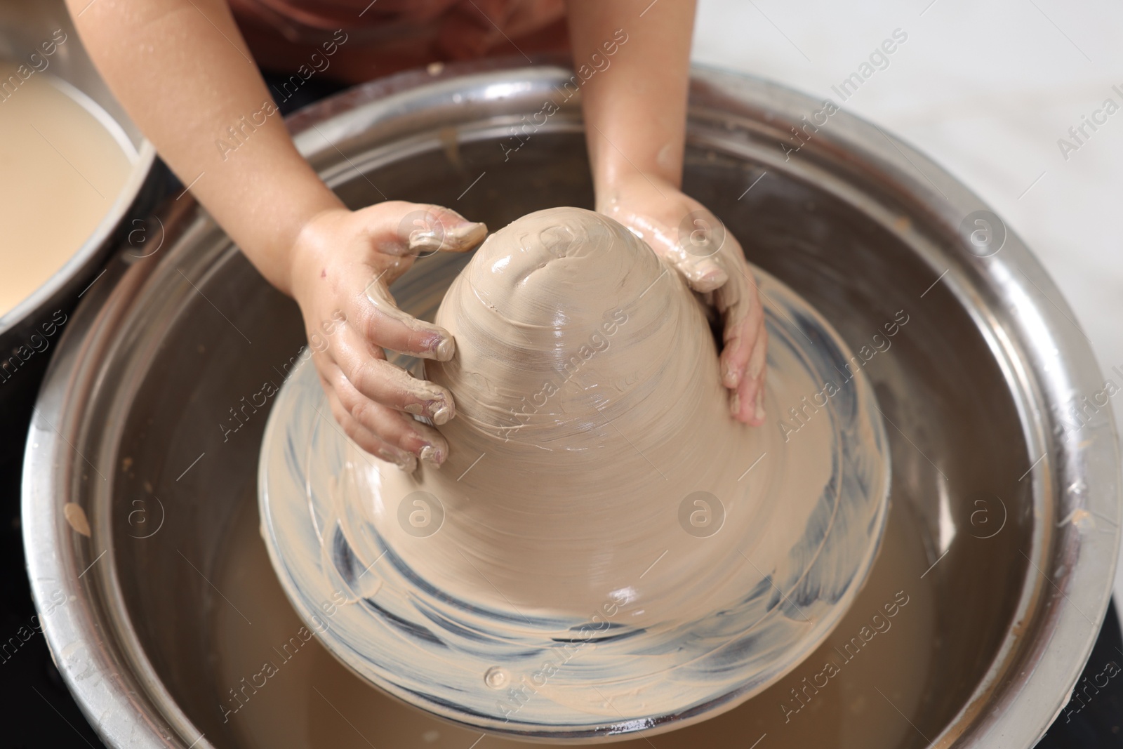 Photo of Hobby and craft. Girl making pottery indoors, closeup