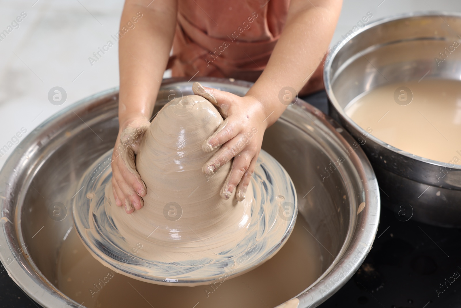 Photo of Hobby and craft. Girl making pottery indoors, closeup