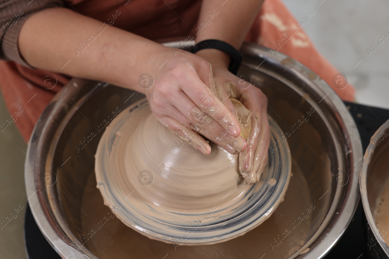 Photo of Hobby and craft. Woman making pottery indoors, closeup