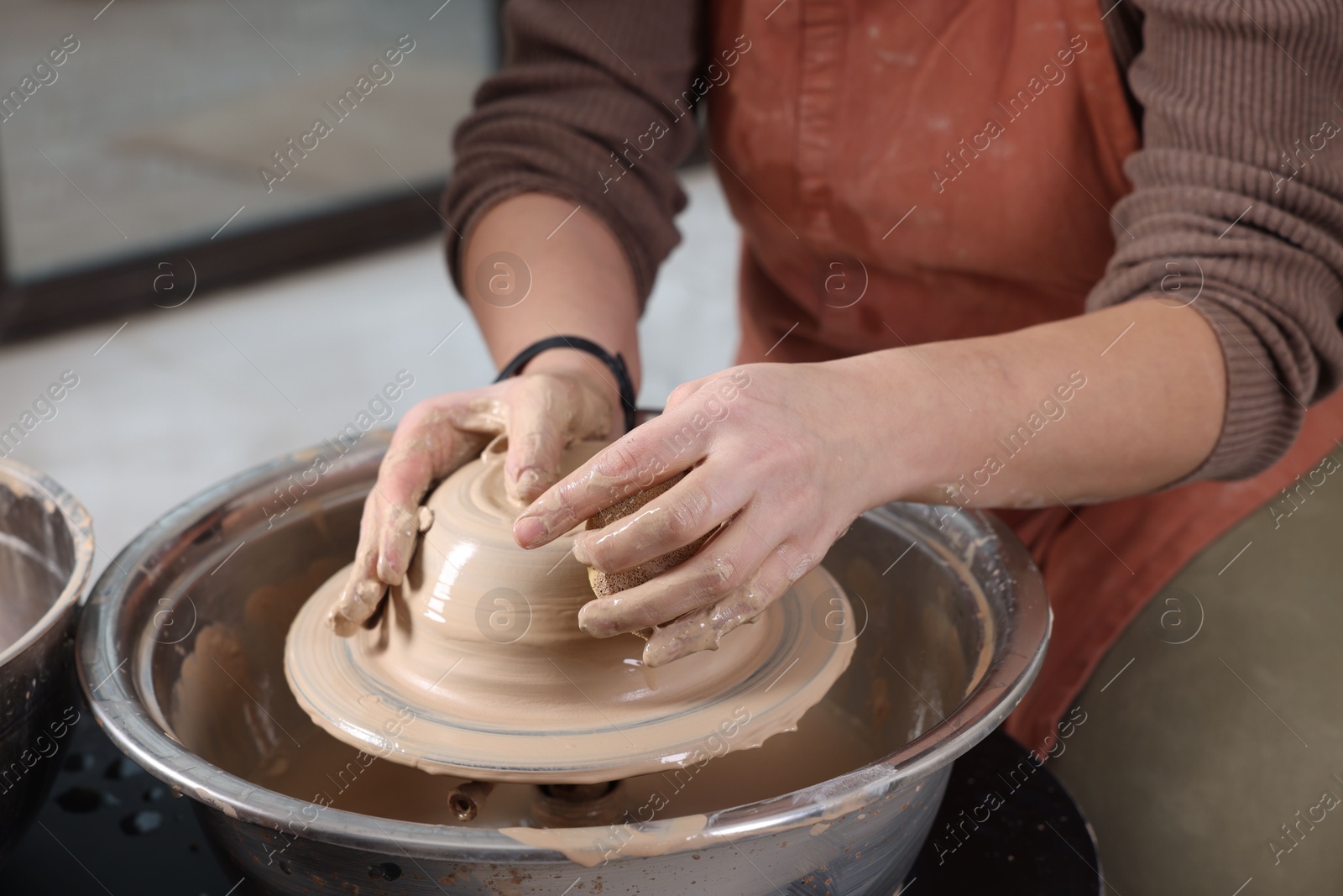 Photo of Hobby and craft. Woman making pottery indoors, closeup