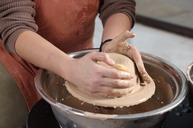 Photo of Hobby and craft. Woman making pottery indoors, closeup