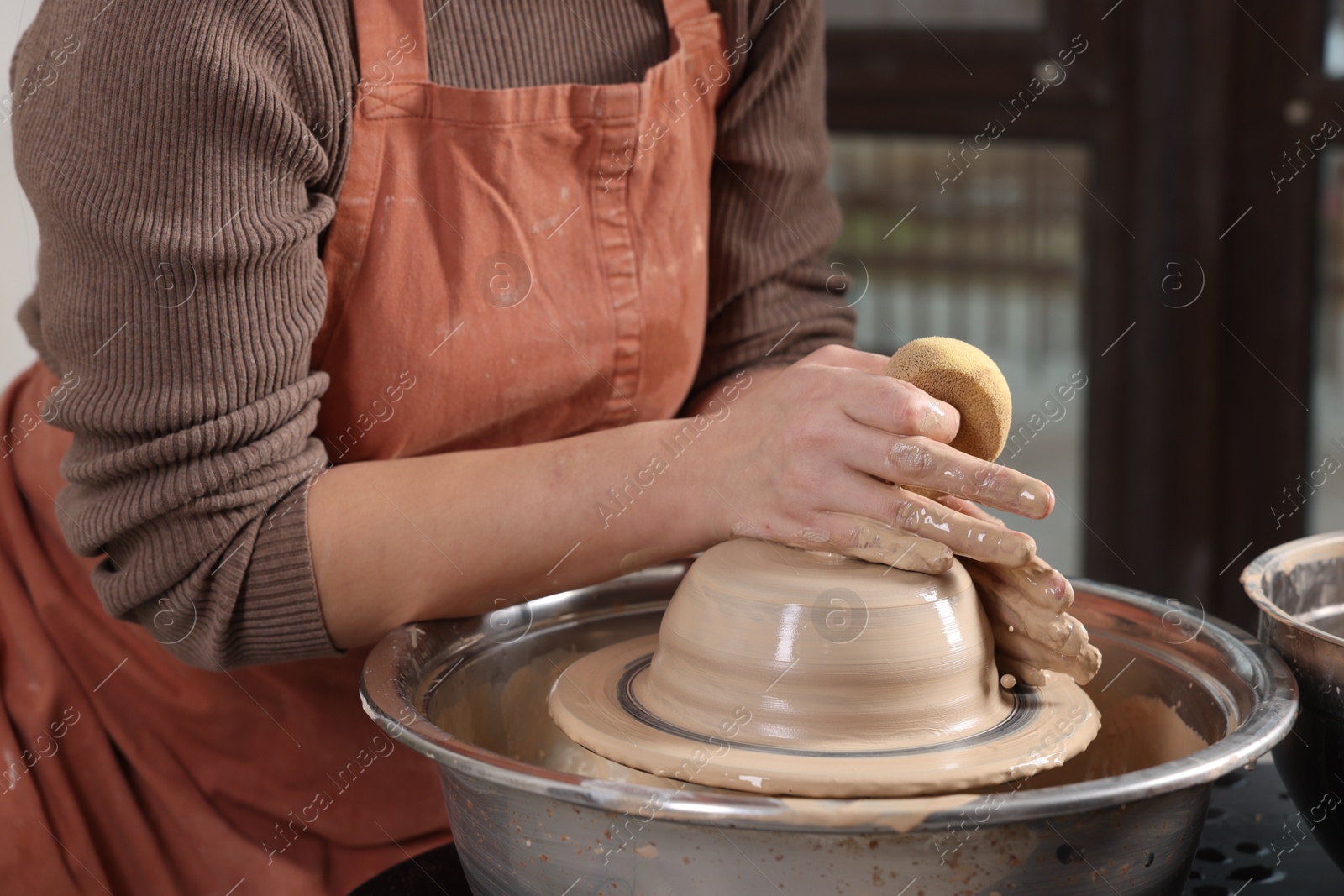 Photo of Hobby and craft. Woman making pottery indoors, closeup