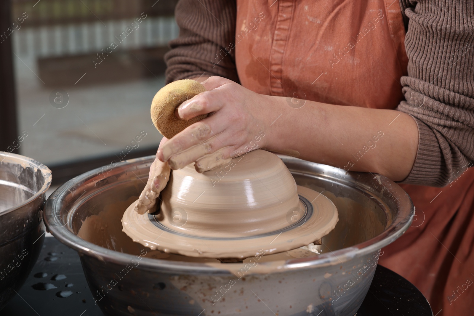 Photo of Hobby and craft. Woman making pottery indoors, closeup