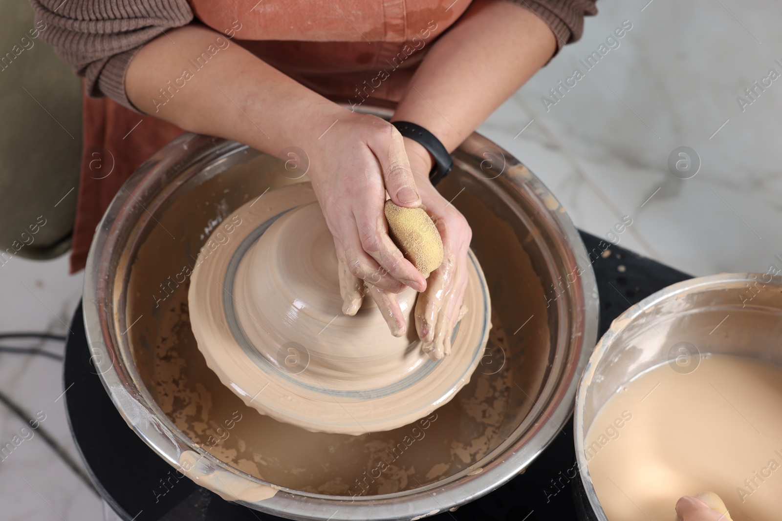 Photo of Hobby and craft. Woman making pottery indoors, closeup