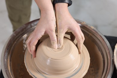 Photo of Hobby and craft. Woman making pottery indoors, closeup