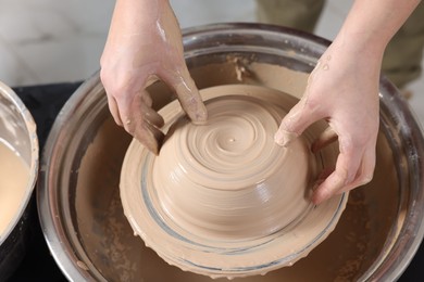 Photo of Hobby and craft. Woman making pottery indoors, closeup