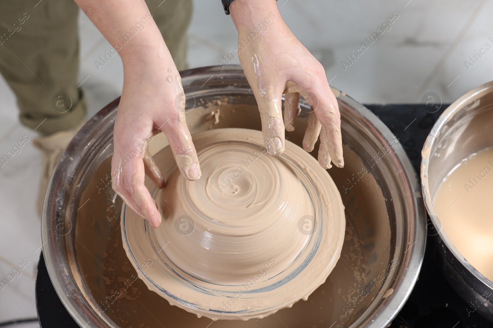 Photo of Hobby and craft. Woman making pottery indoors, closeup