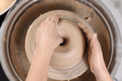 Photo of Hobby and craft. Woman making pottery indoors, above view