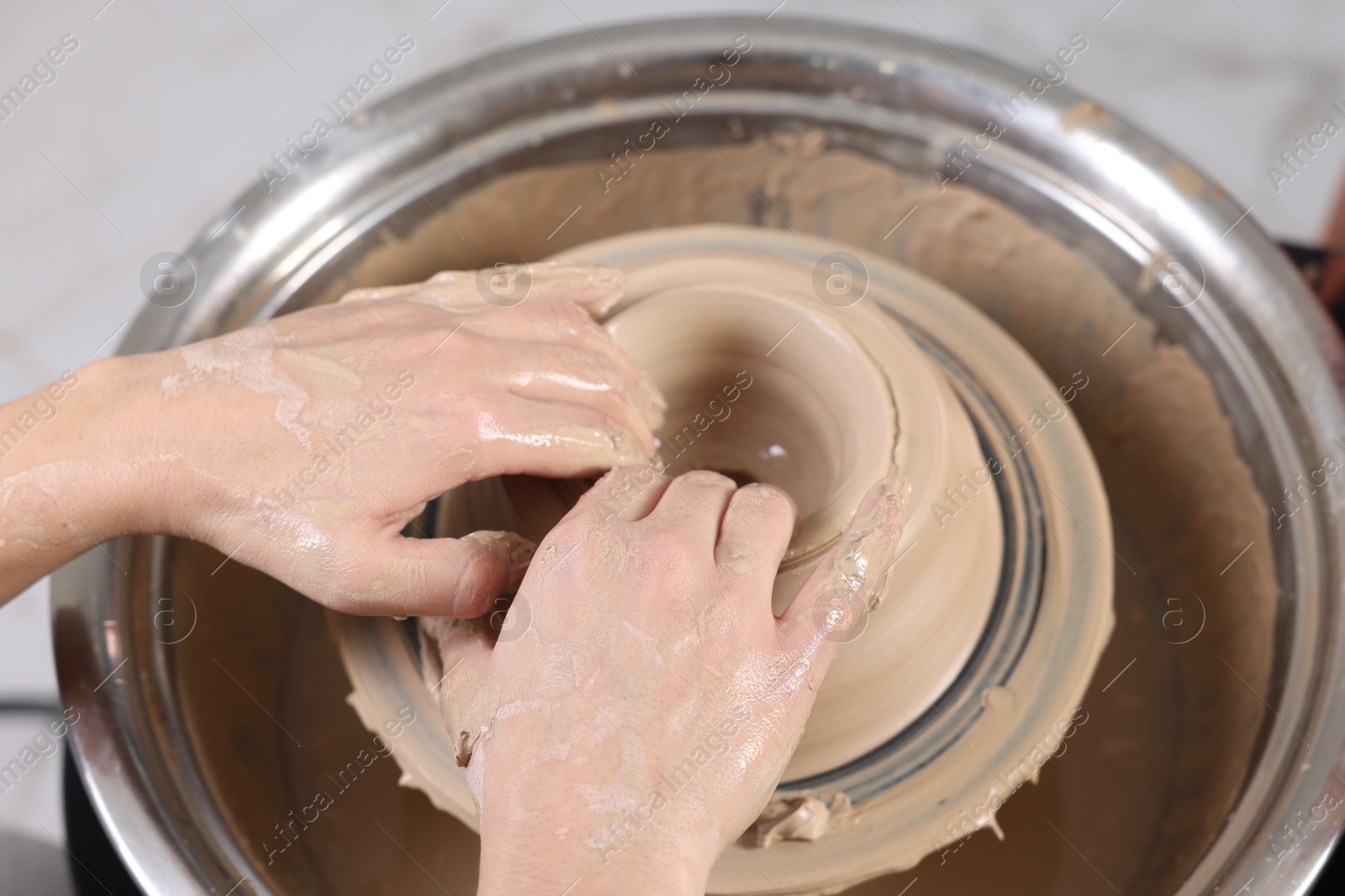 Photo of Hobby and craft. Woman making pottery indoors, closeup