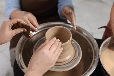 Photo of Hobby and craft. Women making pottery indoors, closeup