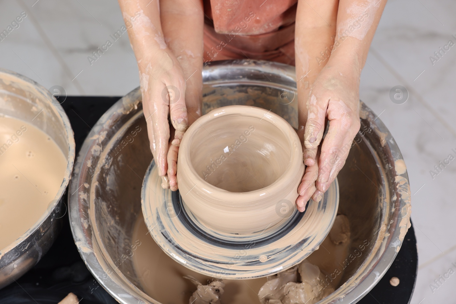 Photo of Hobby and craft. Daughter with her mother making pottery indoors, closeup