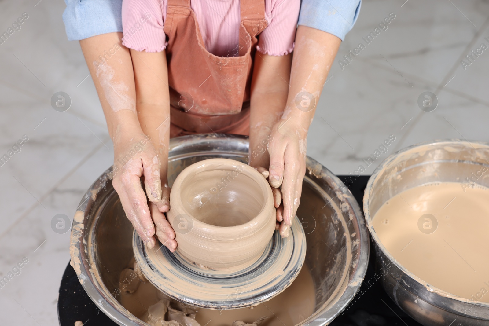 Photo of Hobby and craft. Daughter with her mother making pottery indoors, closeup