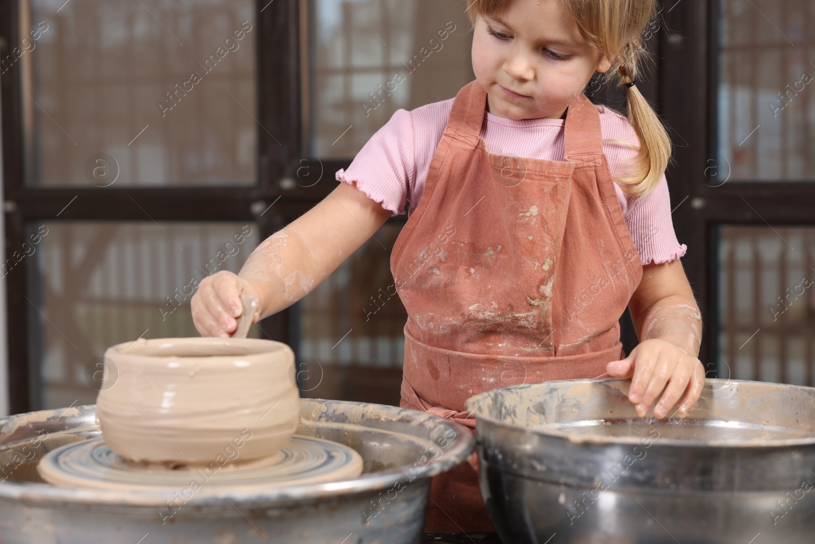 Photo of Hobby and craft. Little girl making pottery indoors