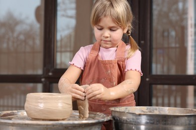 Photo of Hobby and craft. Little girl making pottery indoors