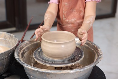 Photo of Hobby and craft. Girl making pottery indoors, closeup