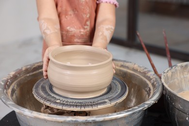 Photo of Hobby and craft. Girl making pottery indoors, closeup