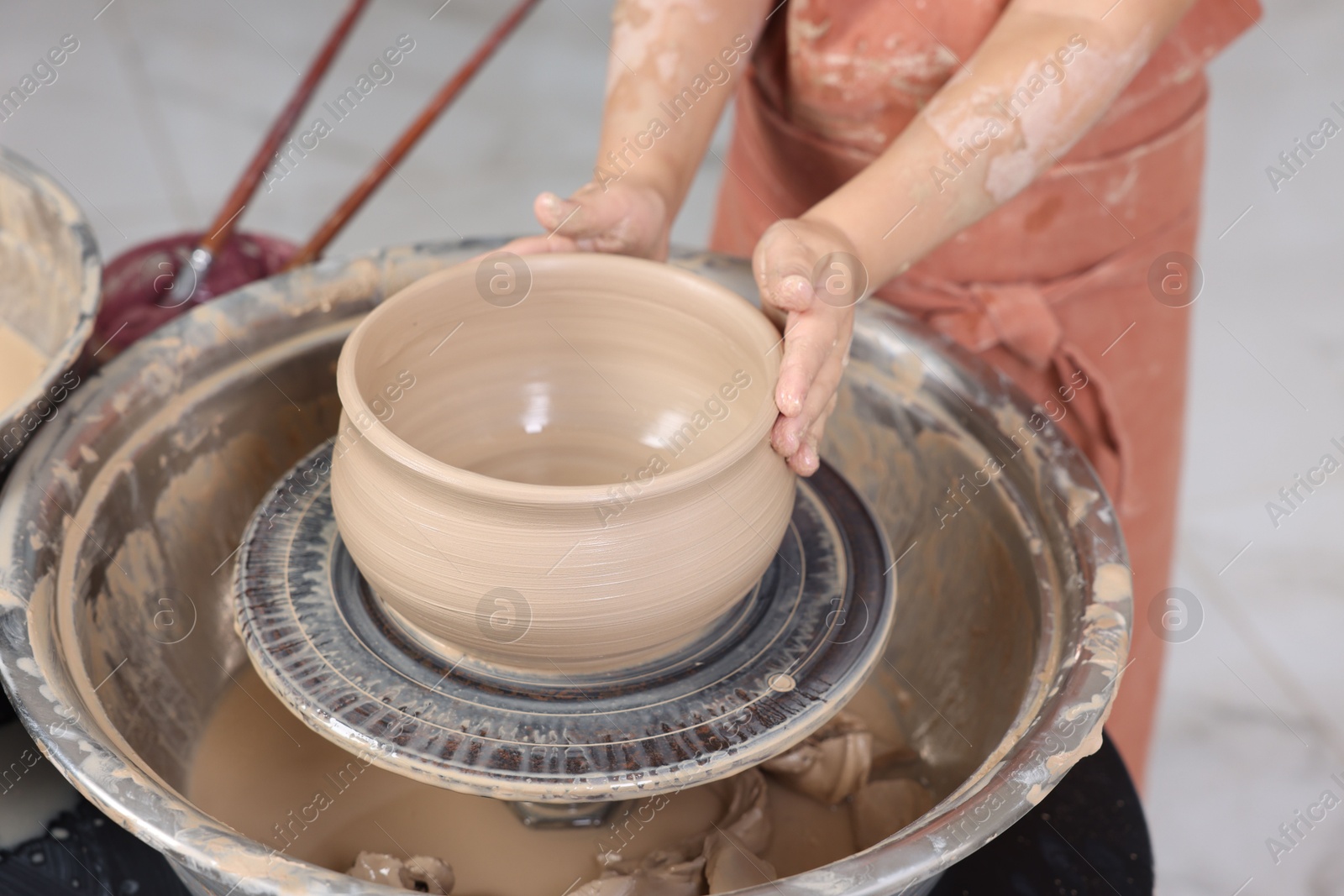 Photo of Hobby and craft. Girl making pottery indoors, closeup