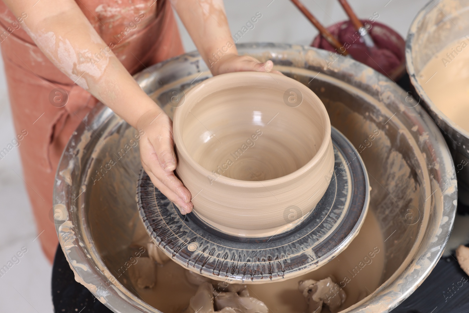 Photo of Hobby and craft. Girl making pottery indoors, closeup