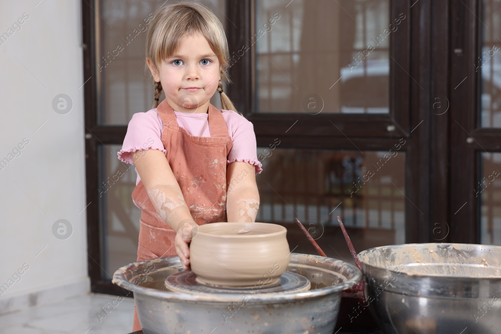 Photo of Hobby and craft. Little girl making pottery indoors