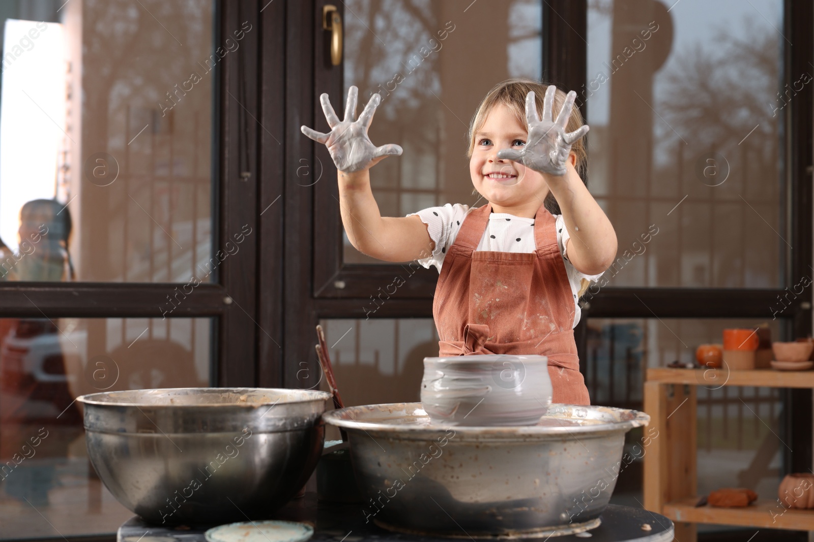 Photo of Hobby and craft. Smiling girl making pottery indoors