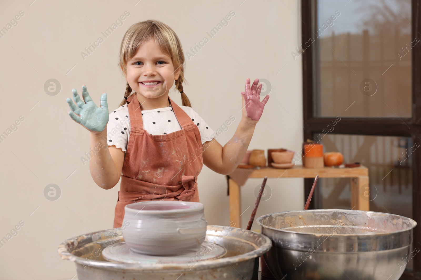 Photo of Hobby and craft. Smiling girl making pottery indoors