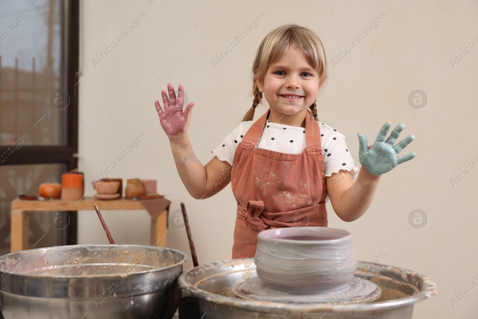 Photo of Hobby and craft. Smiling girl making pottery indoors