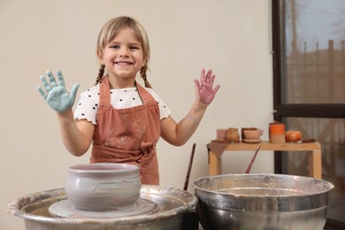 Photo of Hobby and craft. Smiling girl making pottery indoors