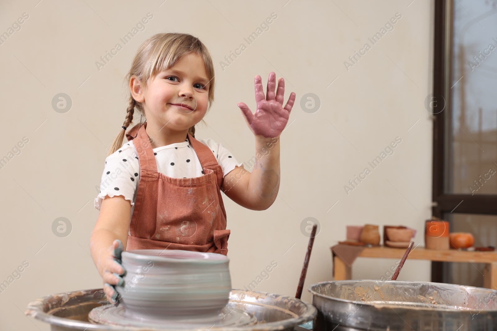 Photo of Hobby and craft. Little girl making pottery indoors