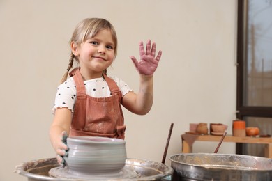 Photo of Hobby and craft. Little girl making pottery indoors