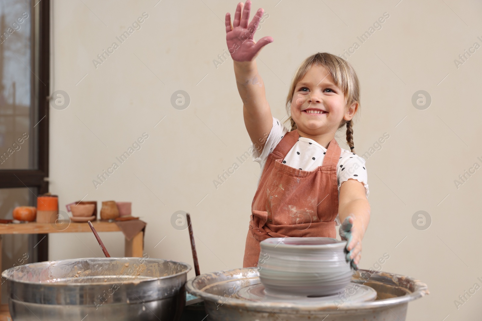 Photo of Hobby and craft. Smiling girl making pottery indoors