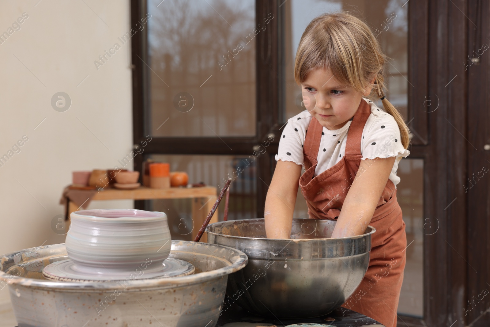 Photo of Hobby and craft. Little girl making pottery indoors