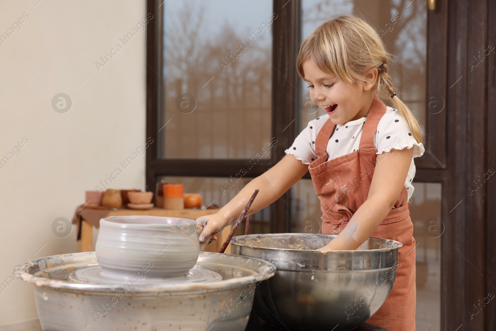 Photo of Hobby and craft. Happy girl making pottery indoors