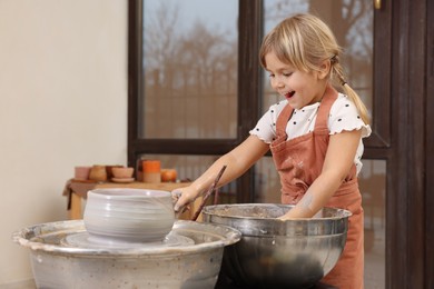 Photo of Hobby and craft. Happy girl making pottery indoors