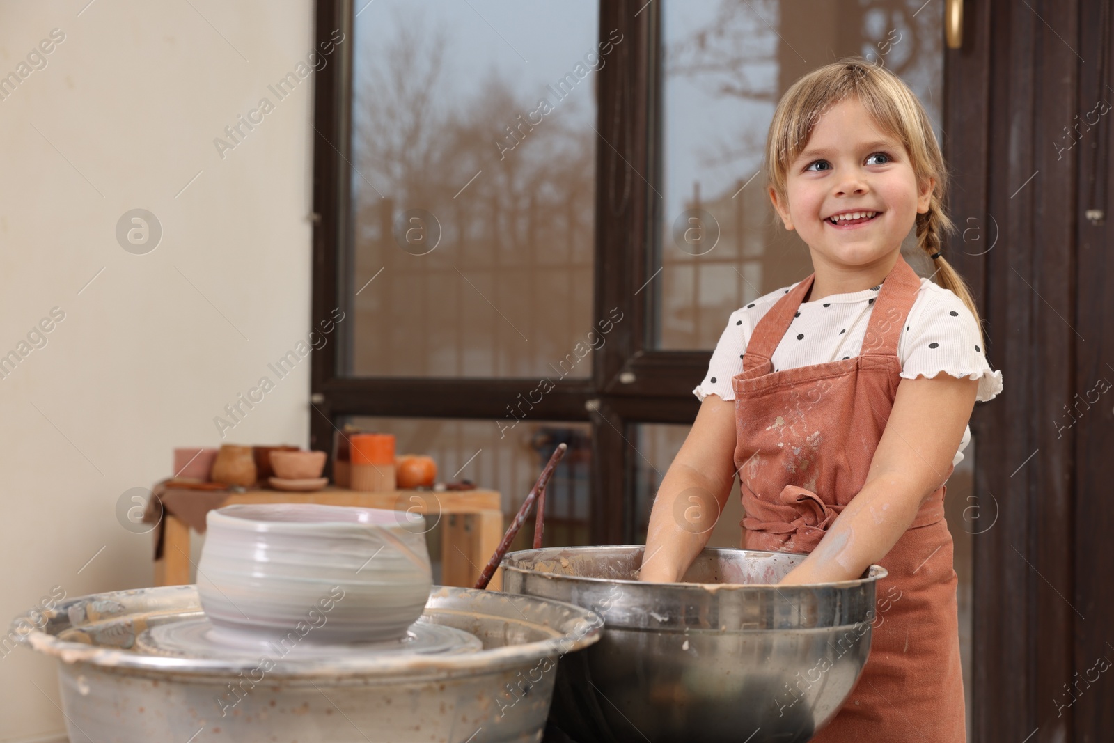 Photo of Hobby and craft. Happy girl making pottery indoors