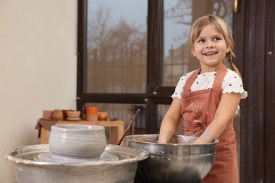 Photo of Hobby and craft. Happy girl making pottery indoors