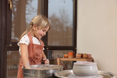 Photo of Hobby and craft. Happy girl making pottery indoors