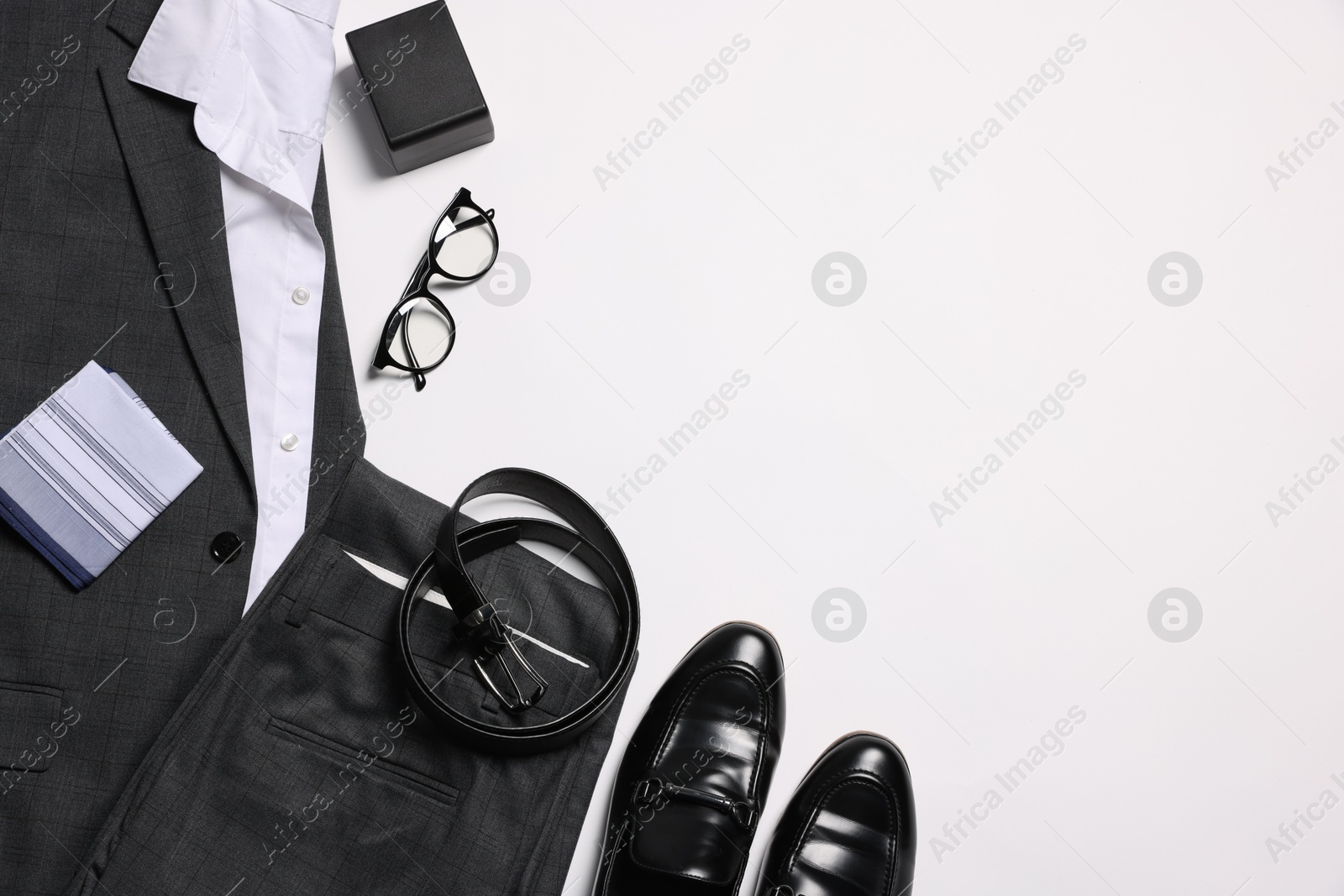 Photo of Elegant men's outfit. Stylish suit, accessories and shoes on white background, flat lay. Space for text