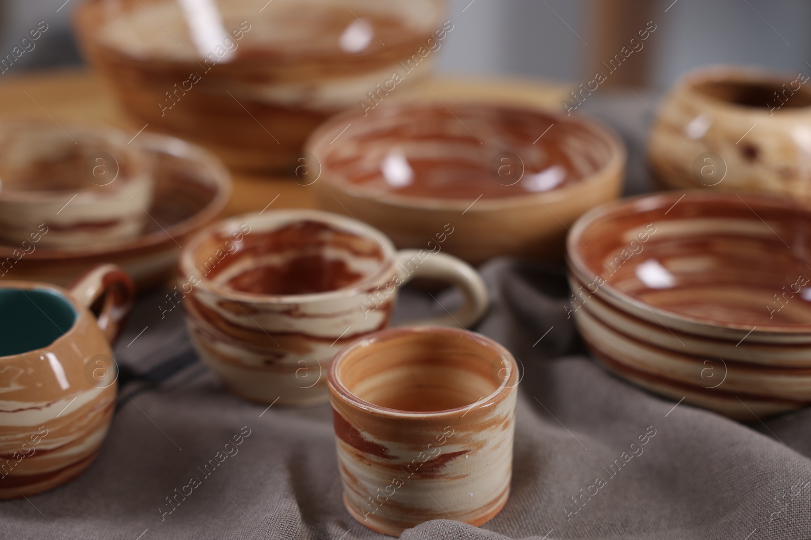 Photo of Hobby and craft. Different beautiful pottery on table, closeup