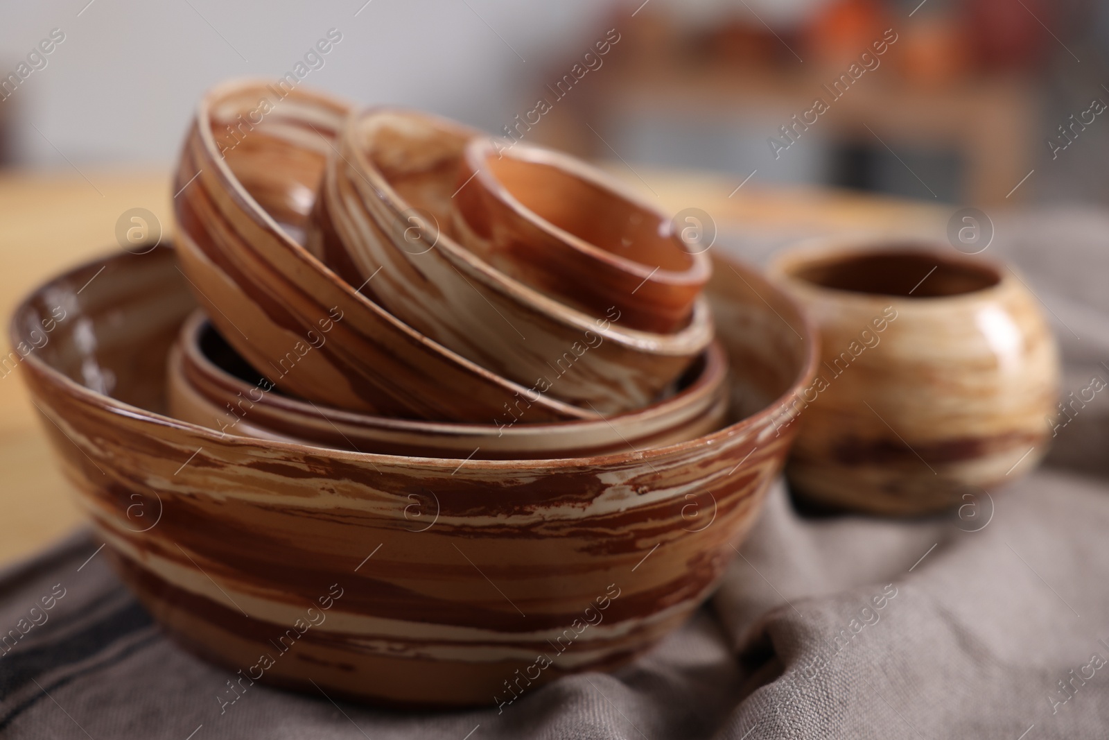 Photo of Hobby and craft. Stack of beautiful ceramic bowls on table indoors, closeup