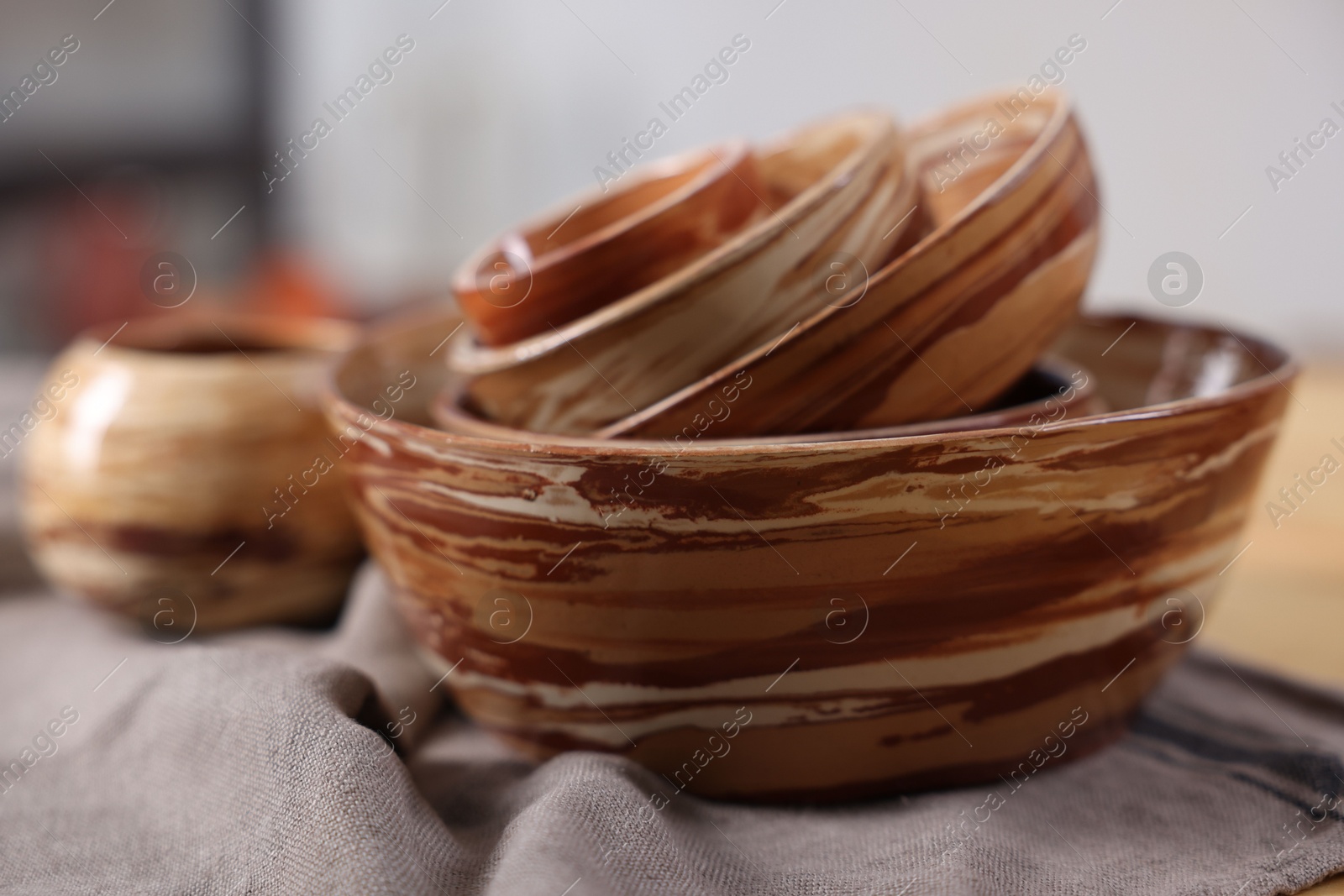 Photo of Hobby and craft. Stack of beautiful ceramic bowls on table indoors, closeup