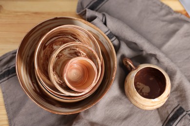 Photo of Different beautiful pottery on wooden table, top view