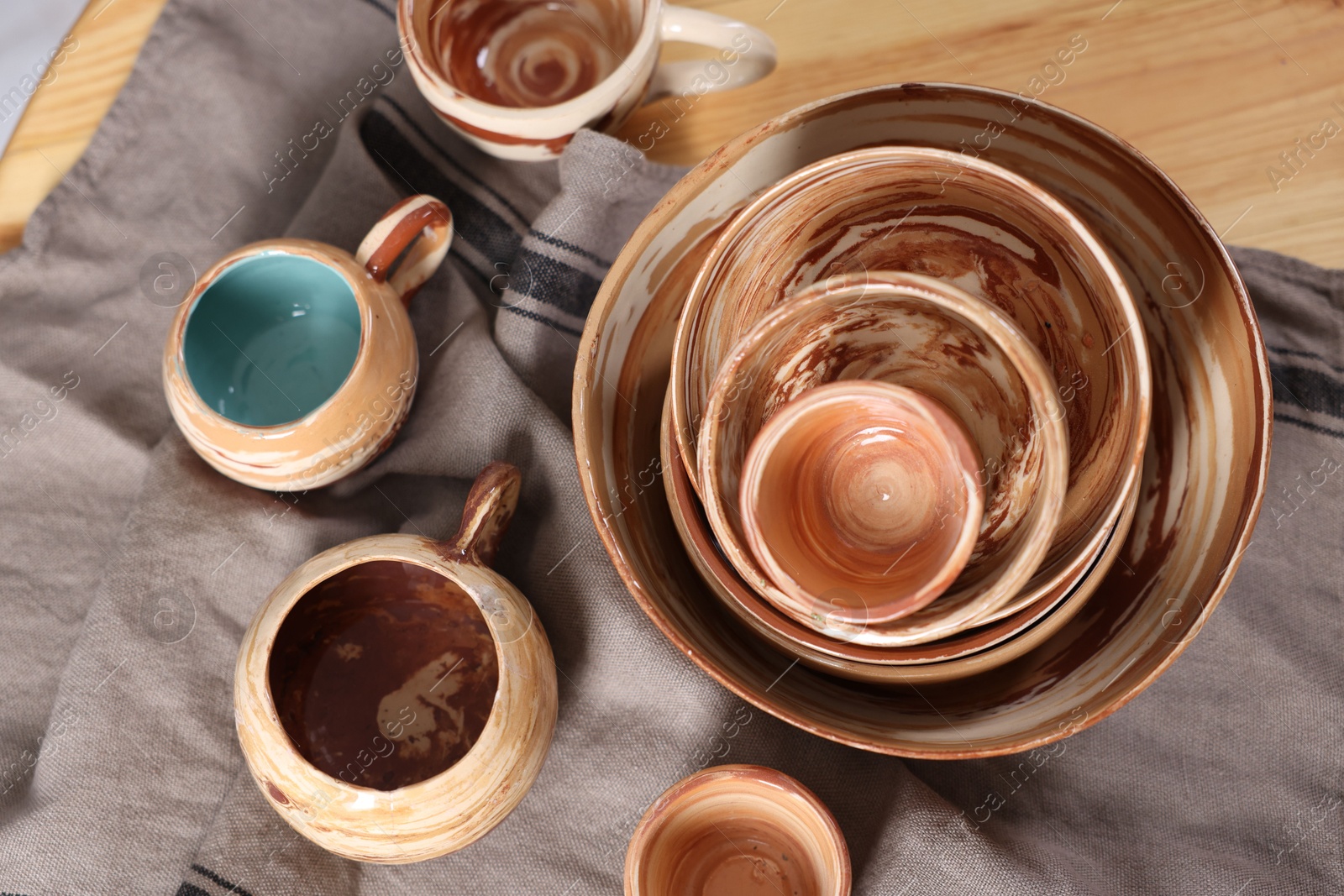 Photo of Different beautiful pottery on wooden table, top view