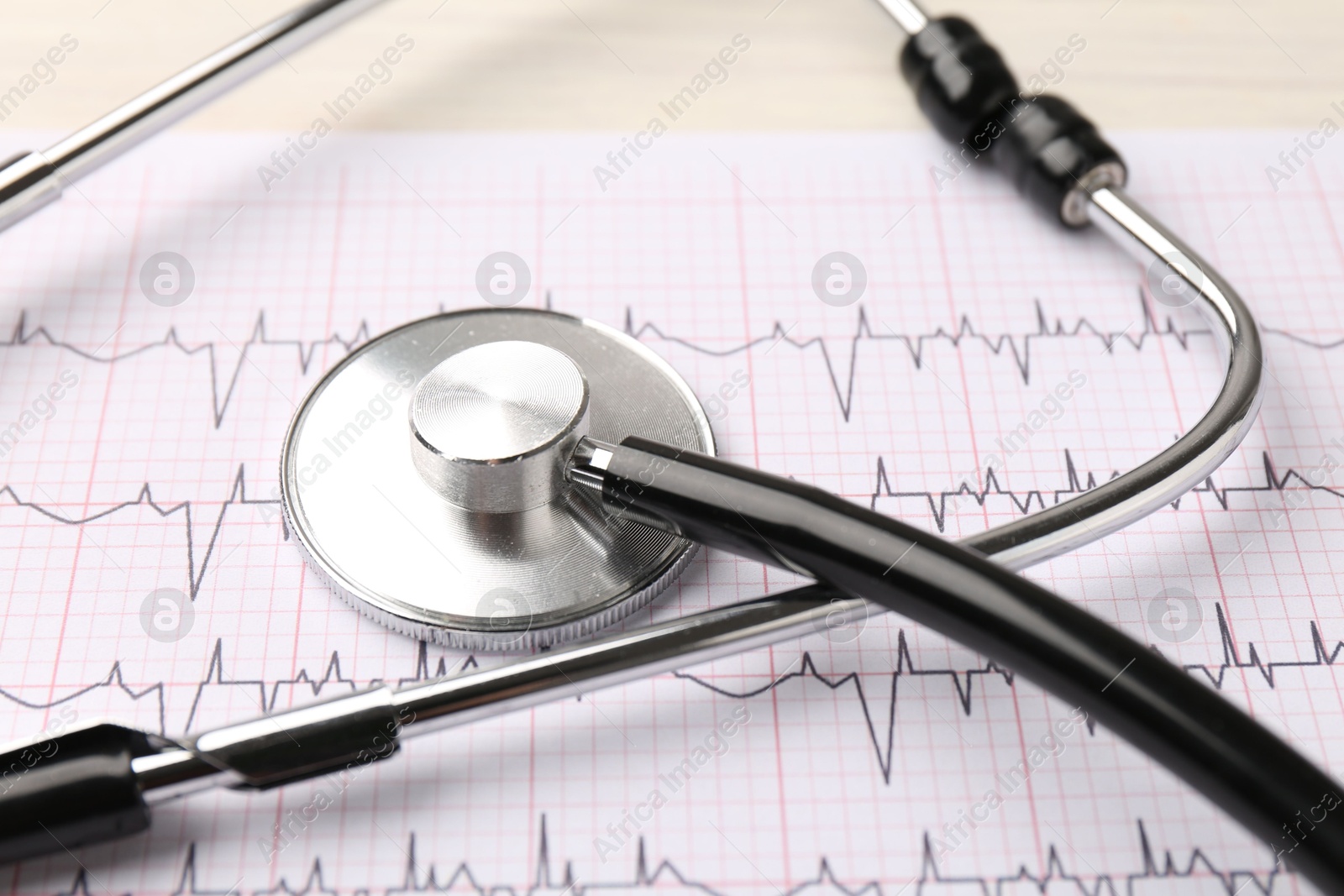 Photo of Cardiology. Stethoscope and cardiogram on table, closeup