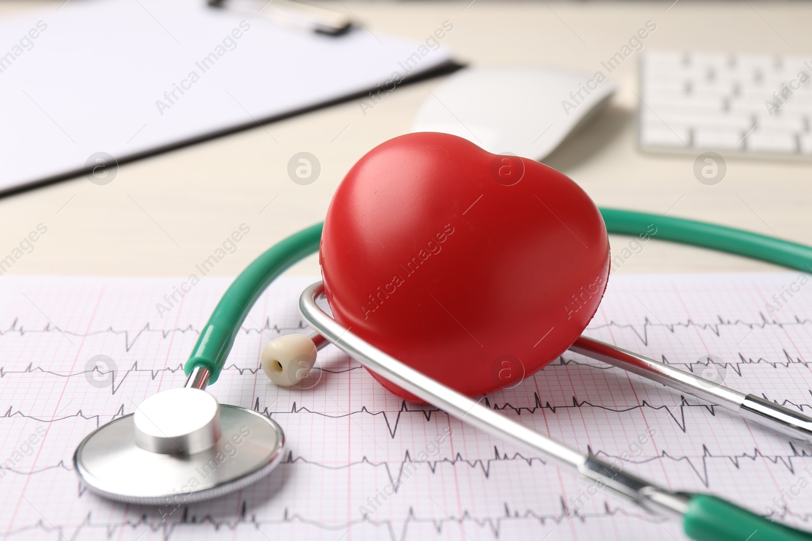 Photo of Cardiology. Stethoscope, cardiogram and red decorative heart on light table, closeup