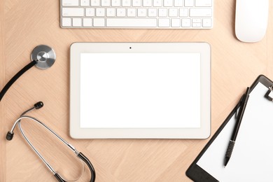 Photo of Cardiology. Flat lay composition with stethoscope and tablet on wooden table