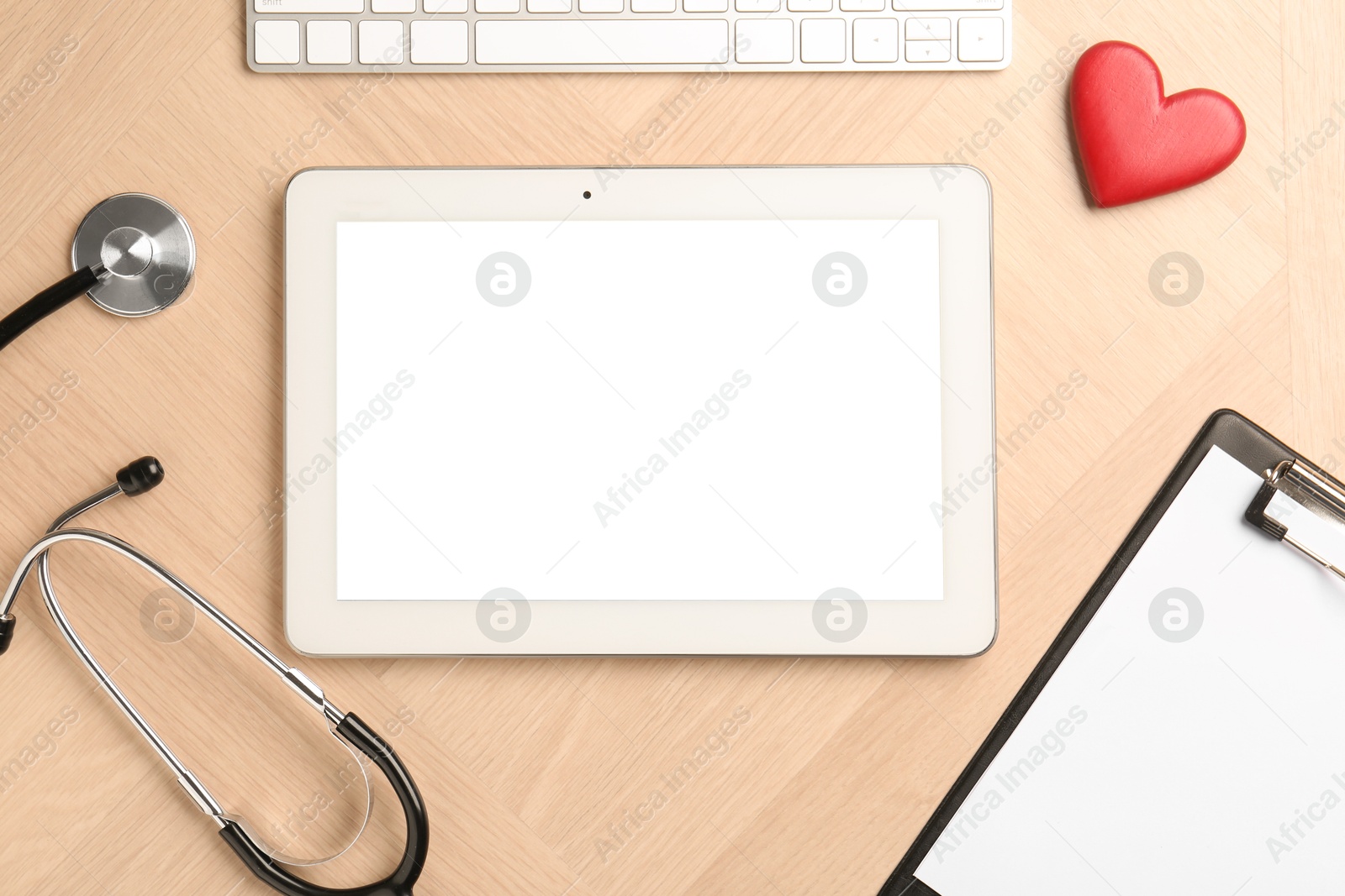 Photo of Cardiology. Stethoscope, tablet, clipboard, keyboard and red decorative heart on wooden table, flat lay