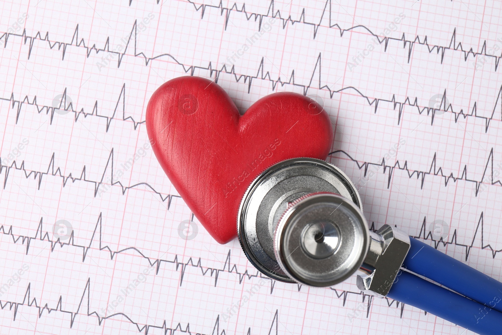 Photo of Cardiology. Stethoscope and red decorative heart on paper with cardiogram, top view. Space for text