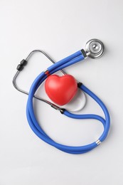 Photo of Cardiology. Stethoscope and red decorative heart on white background, flat lay