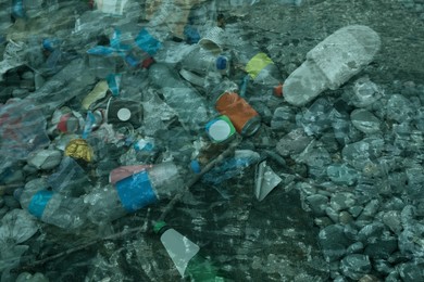 Image of Environmental pollution. Sea beach with plastic garbage